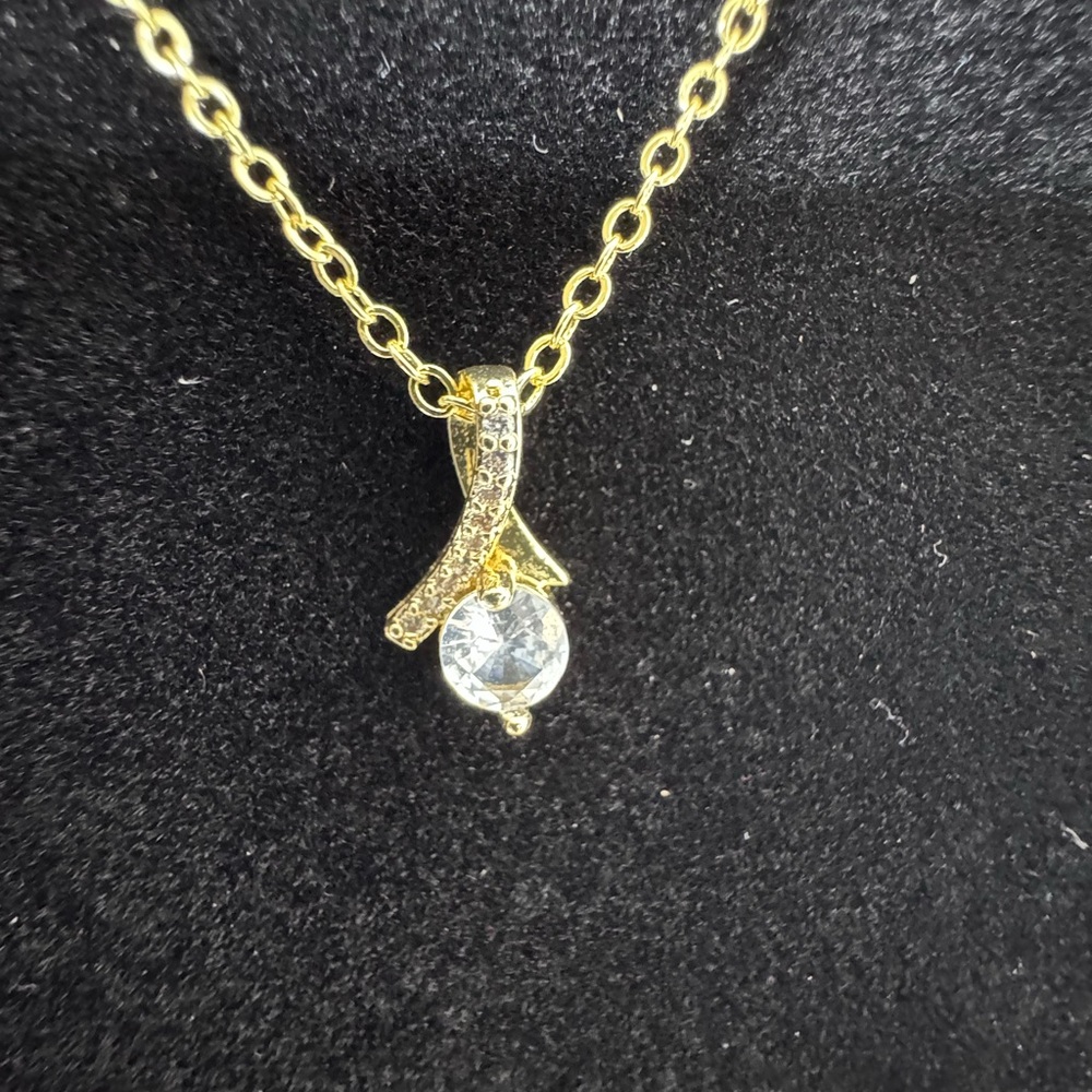 Elegant Gold Ribbon Pendant Necklace with Crystal Accent